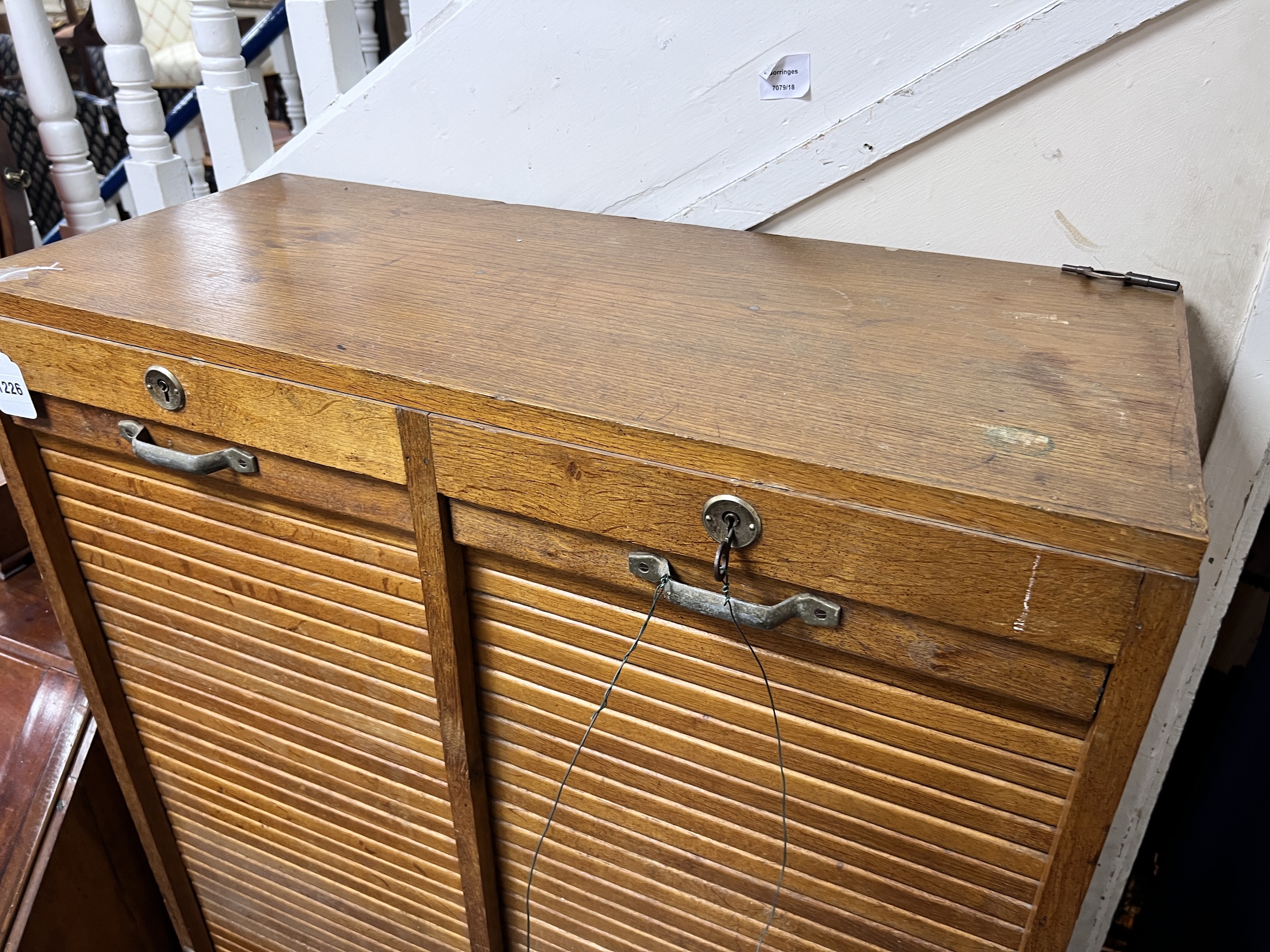 An early 20th century golden oak double tambour front office cabinet, width 82cm, height 150cm